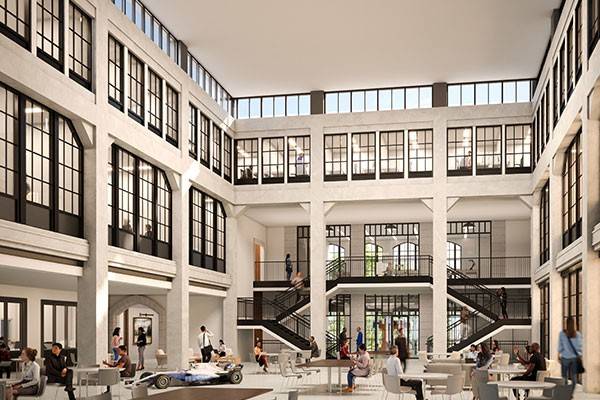Rendering of an atrium with tables and chairs for students on the ground floor and a view up to two more floors of classroom, lab and office spaces.