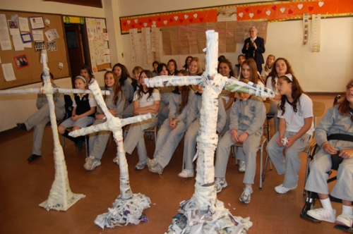 Dr. Dinehart and Abigail led a hands-on engineering project in which students built freestanding newspaper crosses. 