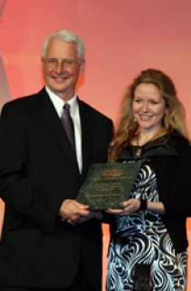 Kenneth C. Hover, President of the American Concrete Institute, presents Dr. Aleksandra Radlinska, Assistant Professor of Civil and Environmental Engineering, with her award.