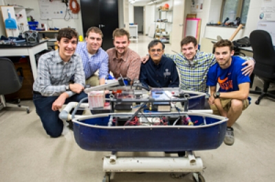 Dr. Nataraj with members of Villanova’s Autonomous Surface Vehicle Team