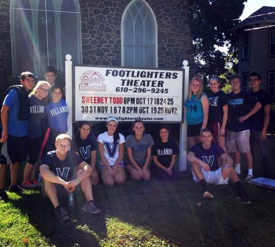 On St. Thomas of Villanova Day of Service, Caroline Franchino ’16 ME (standing next to sign, right side) led the volunteer student group at the Footlighters Theater site.