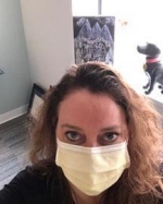Female nurse wearing a mask over her face.