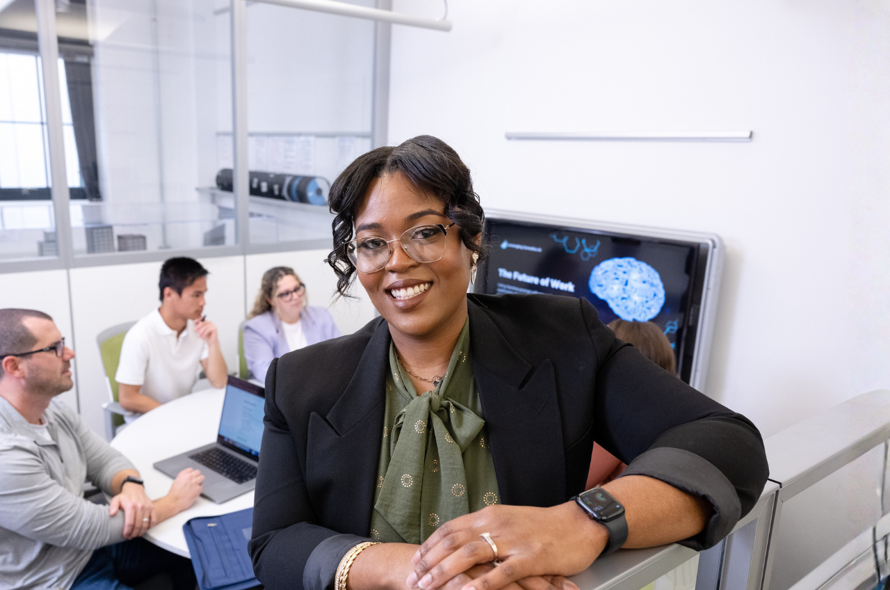 woman standing in front of a team of people