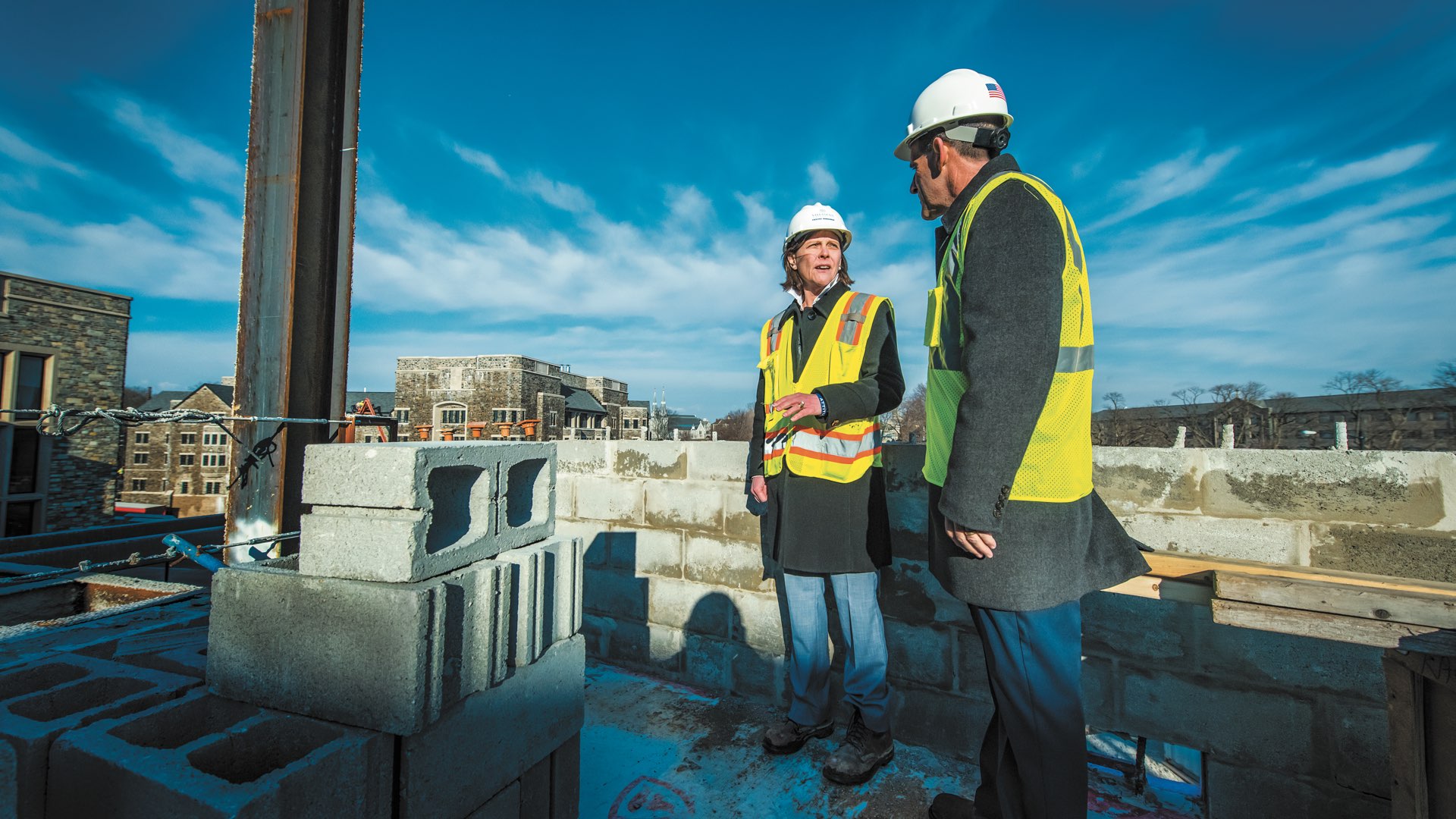 Marilou Smith ‘84 COE and Robert Morro on a construction site at Villanova wearing hard hats and safety vests
