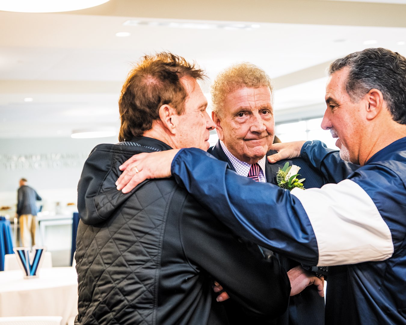 Villanova Class of 1964 alumnus Frank Culotta, a longtime support of Villanova Athletics, stands smiling with two other men