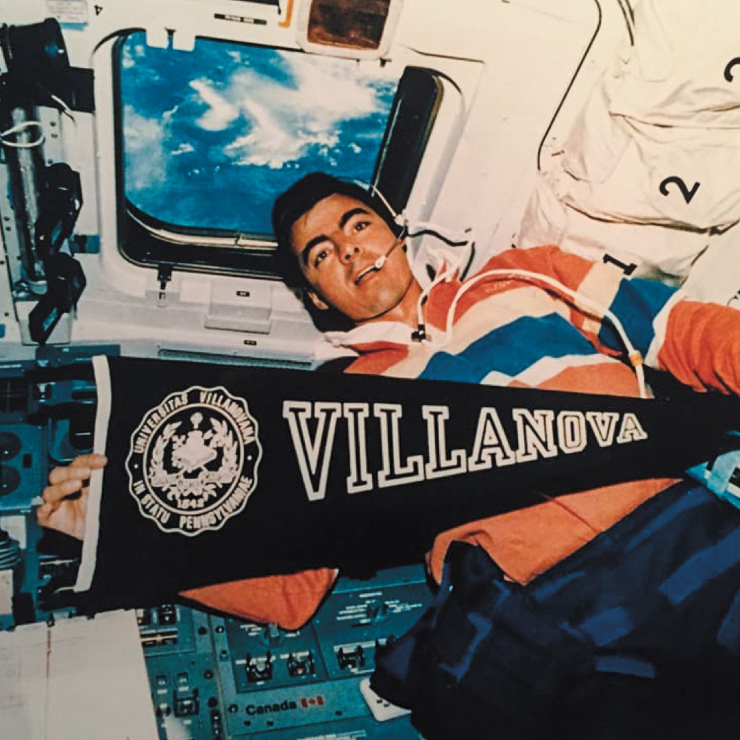 Astronaut and Villanova alumnus Andy Allen holding a Villanova pendant inside a NASA Space Shuttle in outer space in 1992