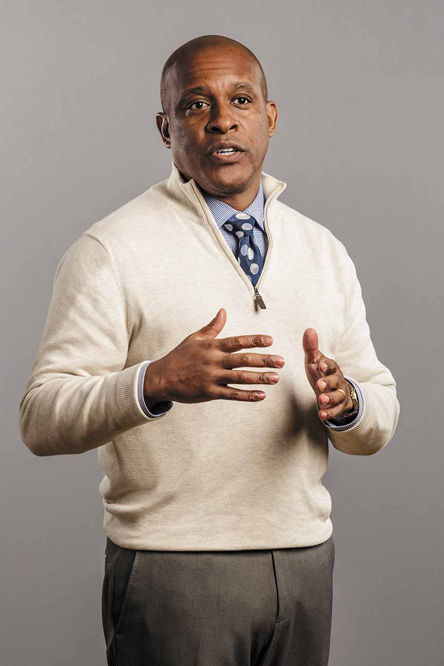 Malcolm Grace standing mid-conversation