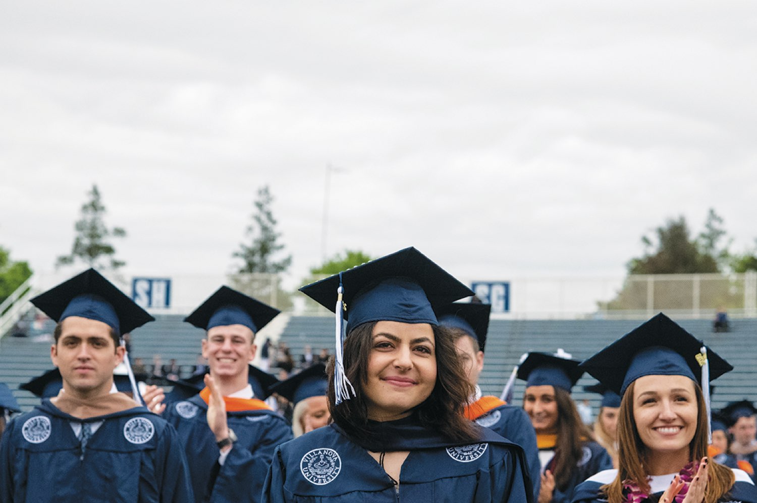 Villanova students wearing graduation robes and standing to be recognized.