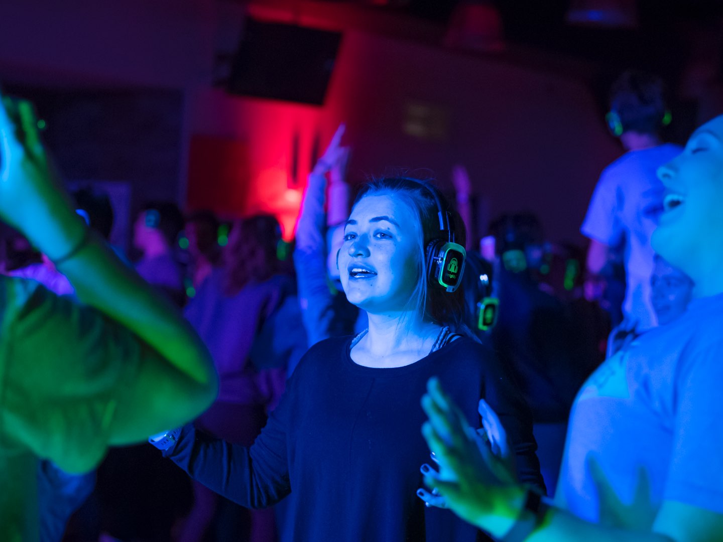 Villanova students dancing at a colorful silent disco.