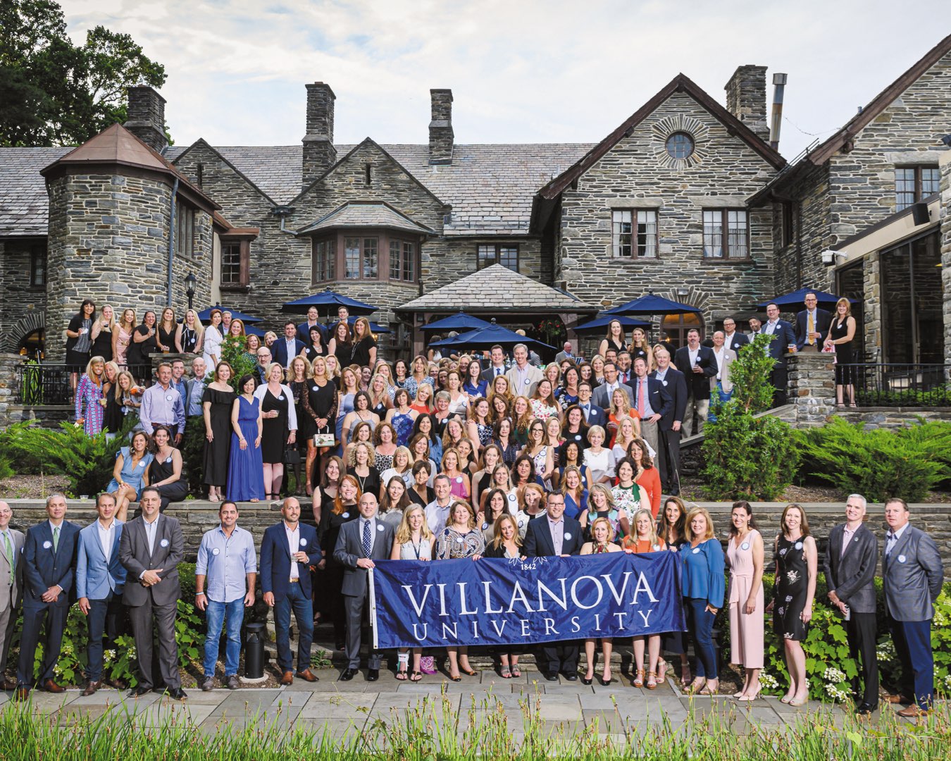 More than 100 alumni on the outdoor stone patio of the Inn at Villanova