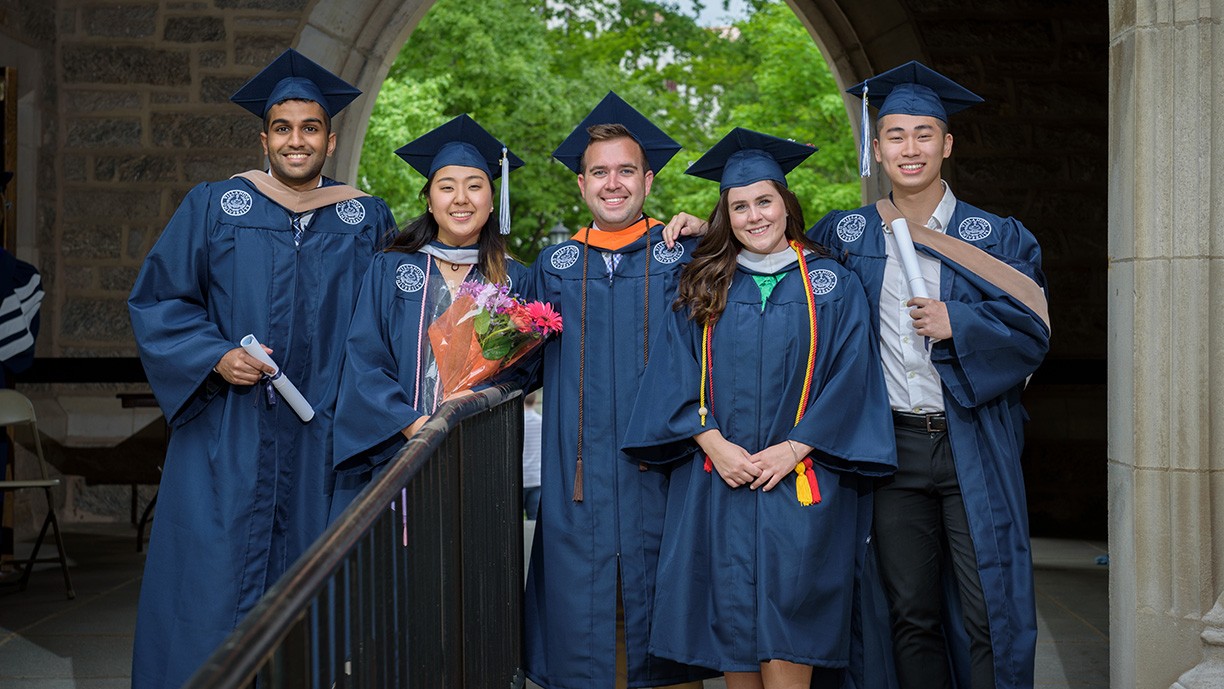 Villanova Alumni 5 Villanova alumni in graduation cap and gowns on campus