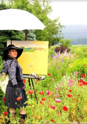 garden-of-miracles Monique Sarkessian standing in a field painting a picture