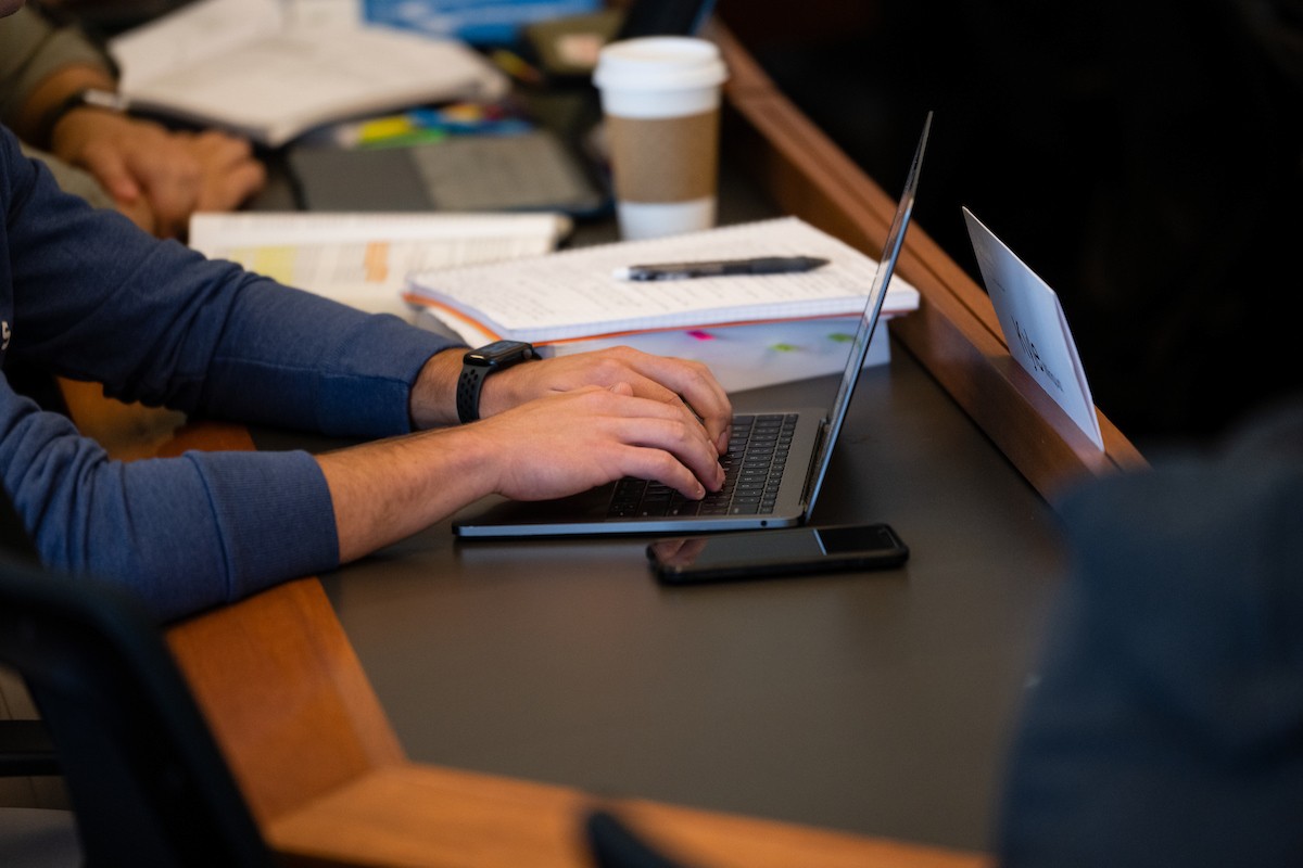 Student's hands typing on a laptop.