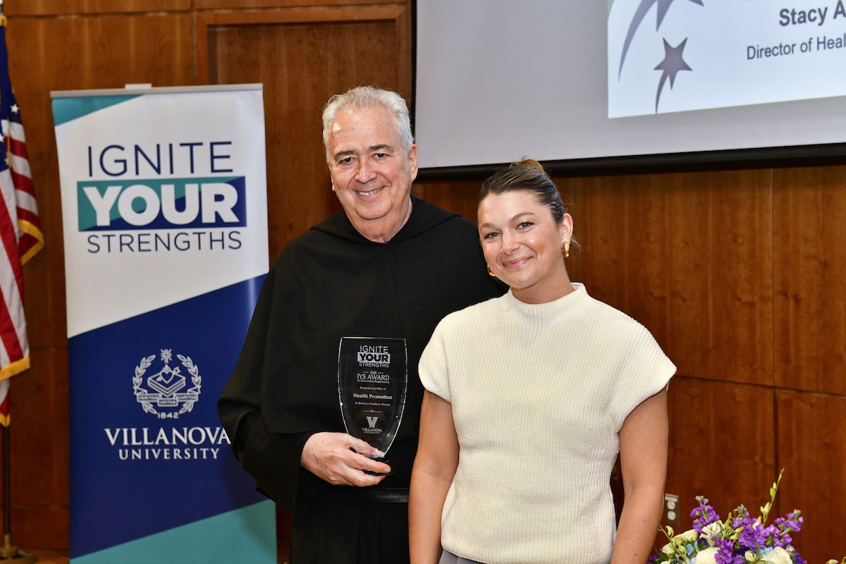 University President the Rev. Peter M. Donohue, OSA, PhD, ’75 CLAS, presents the Ignite Your Strengths Award to Cristina Babyak, Community Well-Being Specialist.