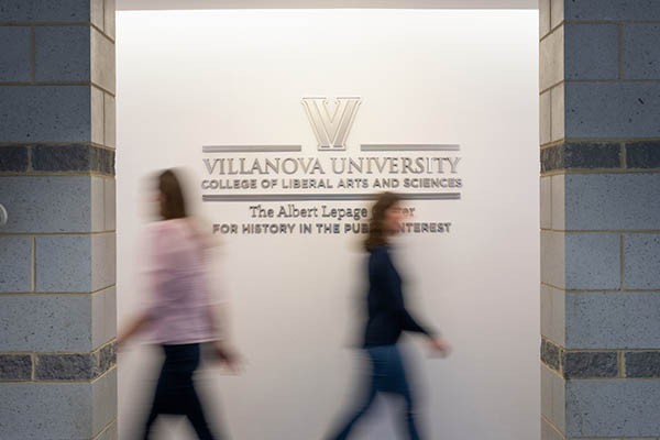 Students walking in front of liberal arts branded wall art