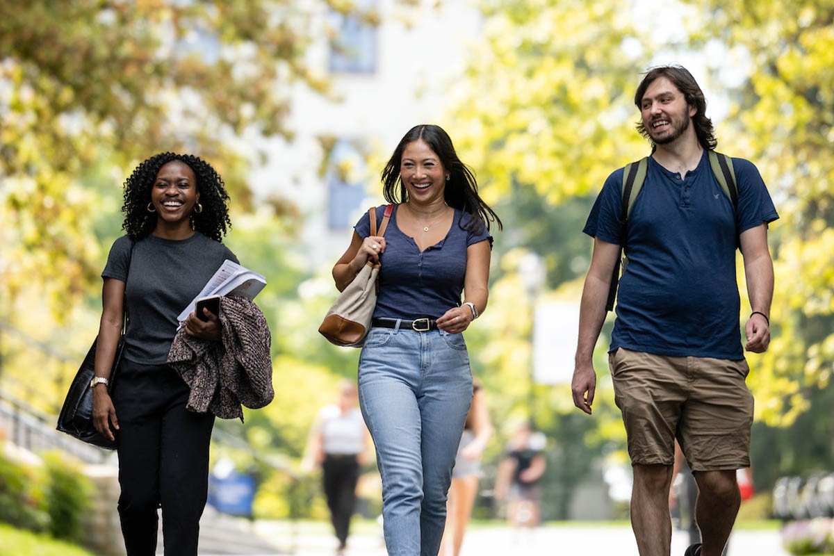 UCM084_20220922_1865 Three students walking and laughing on campus