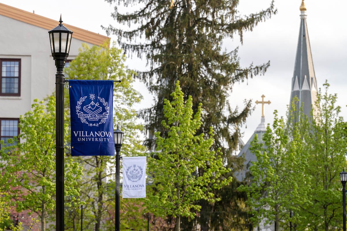 CSP656_20230427_0630 Still image of campus with Villanova flags and church in background