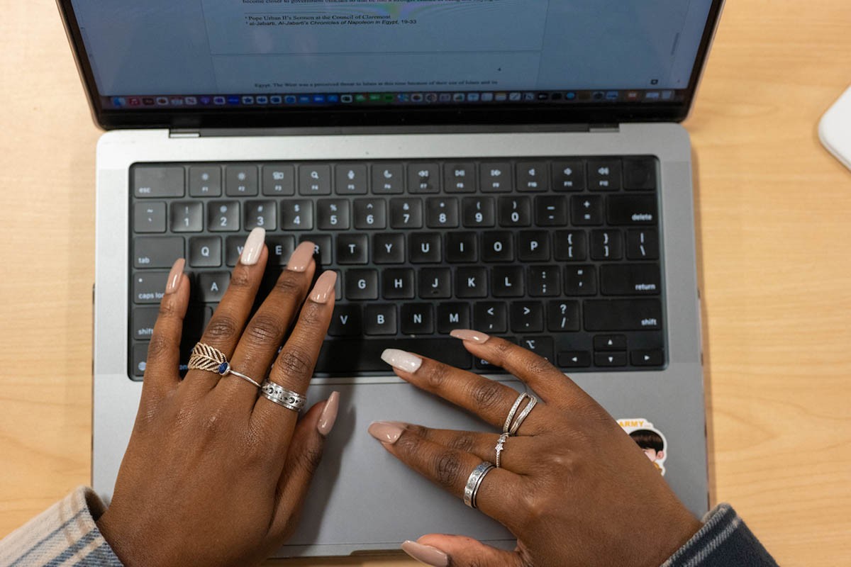 Overhead shot of a person's hands at a computer