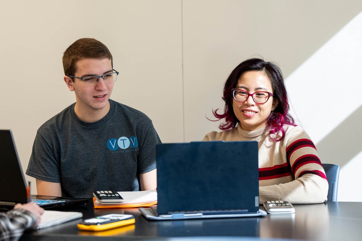 ASU503_20250319_0683 Two people looking at a laptop