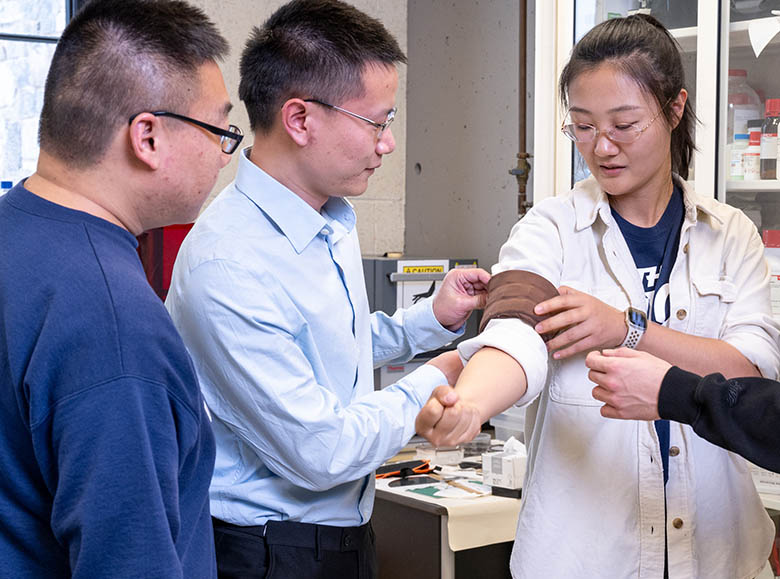 Students working on the Smart Sleeve device