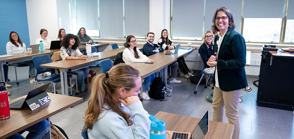 faculty member teaching in front of a room of students