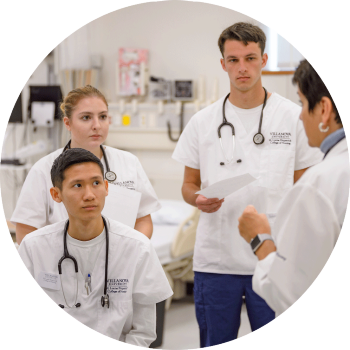 Nursing students listen to their instructor.
