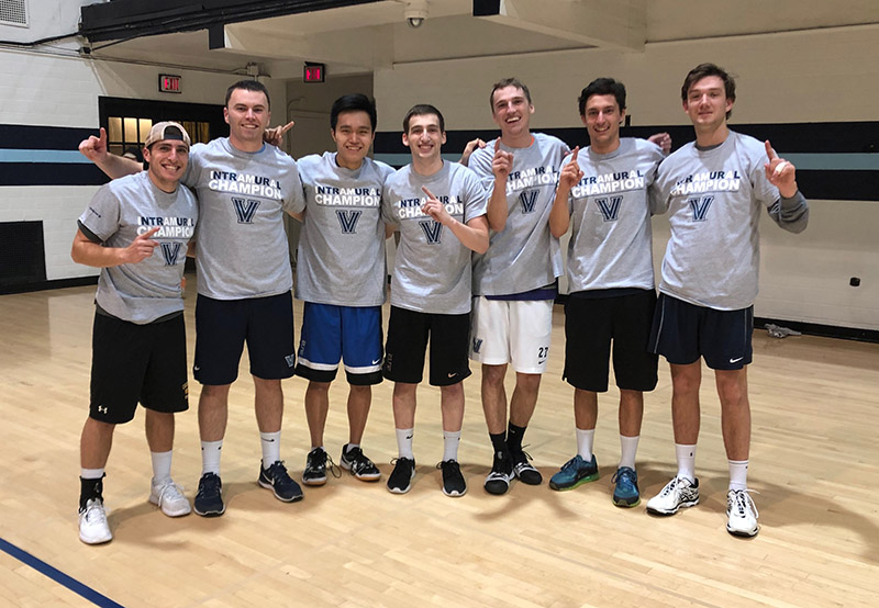 Male students posing for indoor volleyball champion photo