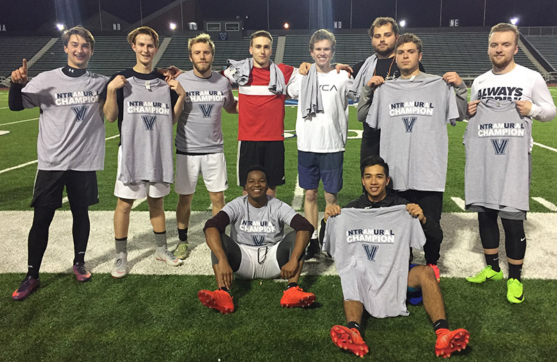 Male students posing for soccer champion photo