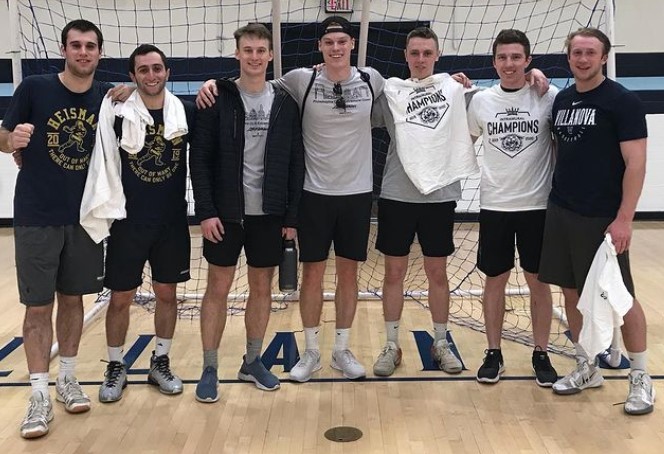 Male students posing for handball champion photo