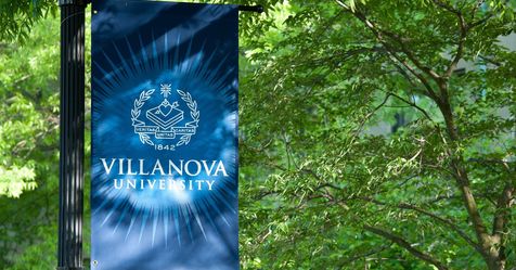 Villanova banner in front of trees