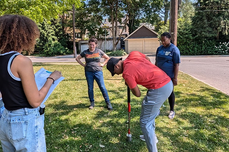 Students taking core soil samples