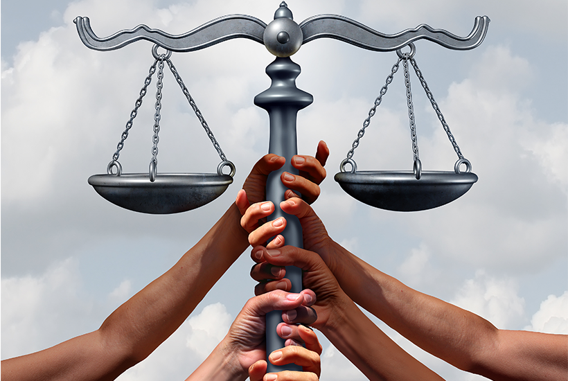 hands of people from different backgrounds holding a scale