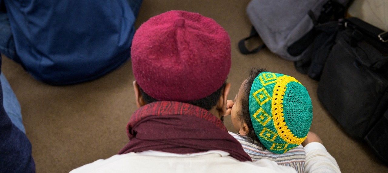 back view of father holding son