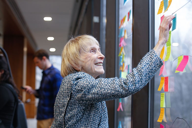 Woman posting a note on a window