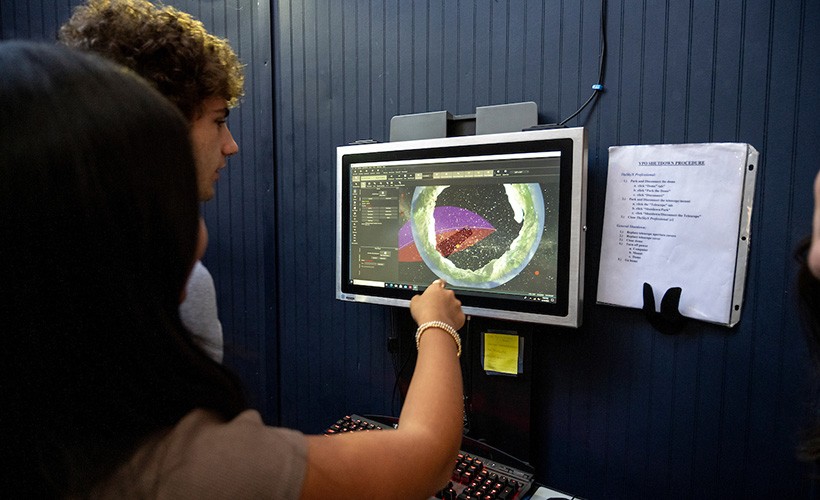 Students look at a view of the sky in the Villanova observatory.