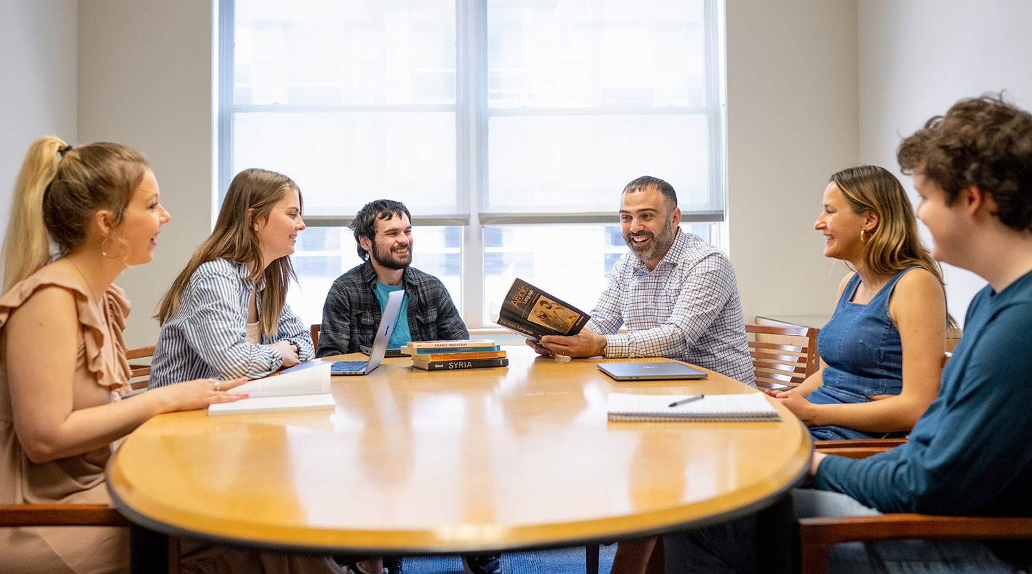 Dean's Fund for Strategic Initiatives Professor and students around a table