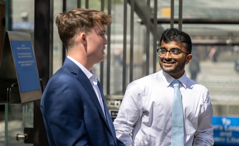 Two students at a professional event.