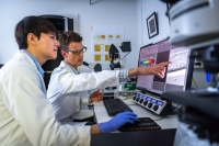 Biology graduate student and faculty using advanced imaging technology Biology graduate student and faculty using advanced imaging technology