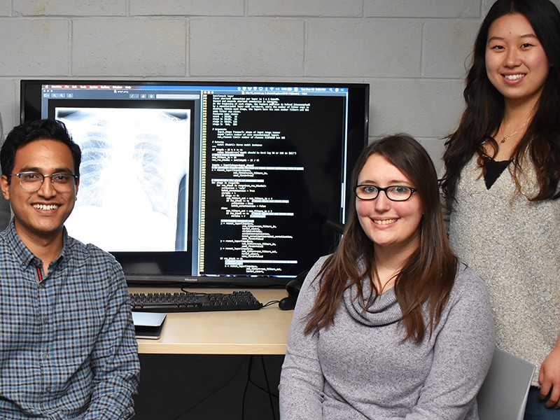 Jessica Yarnall '20 MS (seated, right) was part of a Villanova research team that trained artificial intelligence to recognize warning signs in chest X-rays. Jessica Yarnall '20 MS (seated, right) was part of a Villanova research team that trained artificial intelligence to recognize warning signs in chest X-rays.