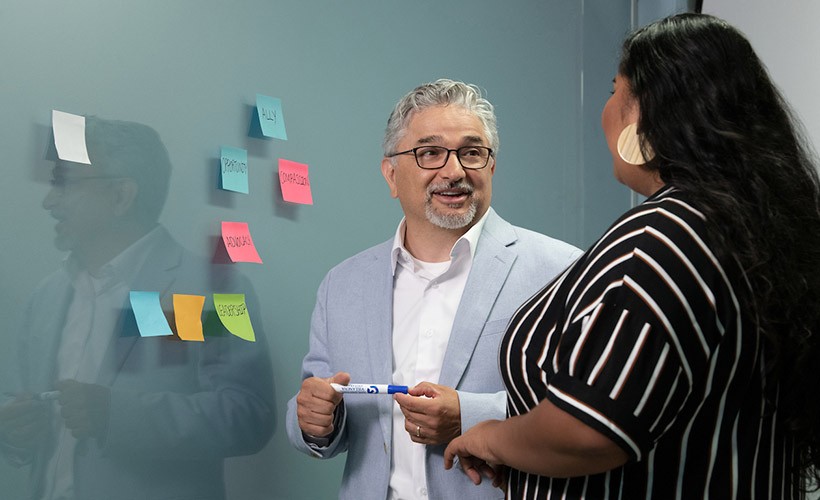 Edward Fierros, PhD, associate dean of Diversity, Equity and Inclusion, talks with a student.