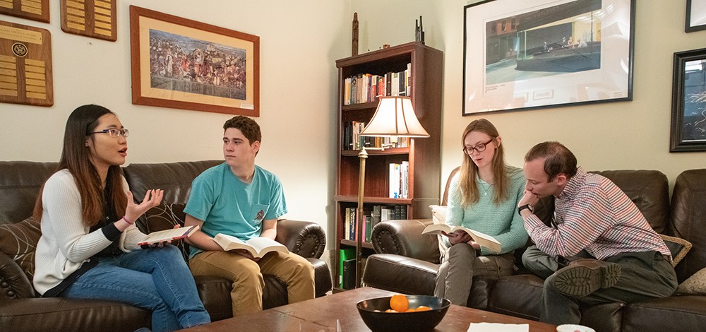 Students sitting on couches and discussing literature