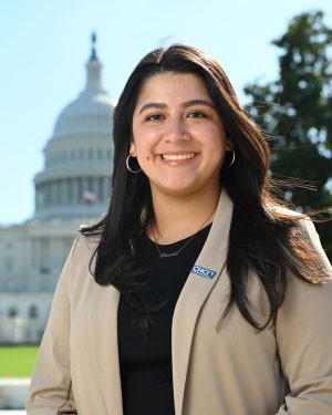 image of smiling woman in front of building