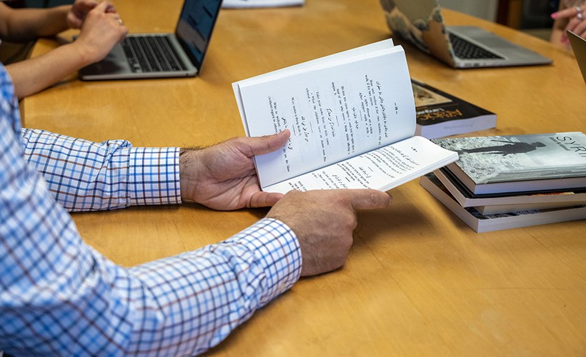 image of hands holding book.