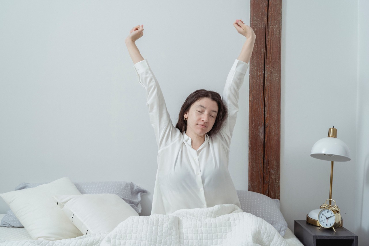 Woman stretching in bed Woman stretching in bed