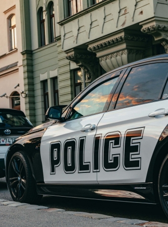 A police car is parked on the street in an urban neighborhood.