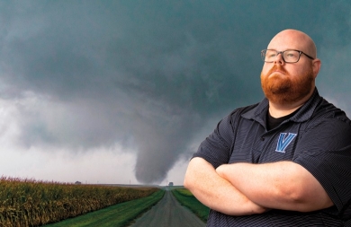 Dr. Strader, a severe weather geographer, analyzed more than 475 large outdoor gatherings in the U.S., ranking them for greatest risk of lightning and tornado events. Dr.Strader posing in front of an image of a tornado