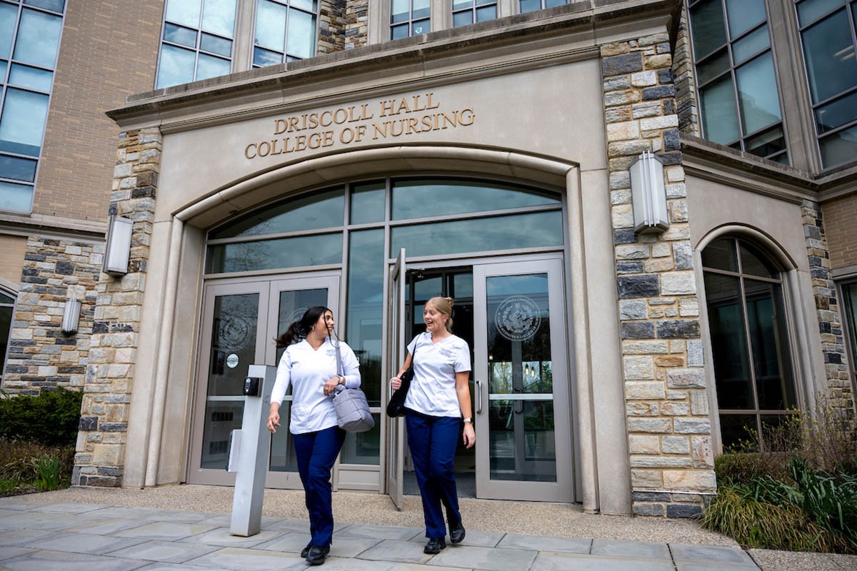 Two nursing students walking out of Driscoll Hall