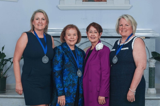 Three women and Dean Havens posing with their awards