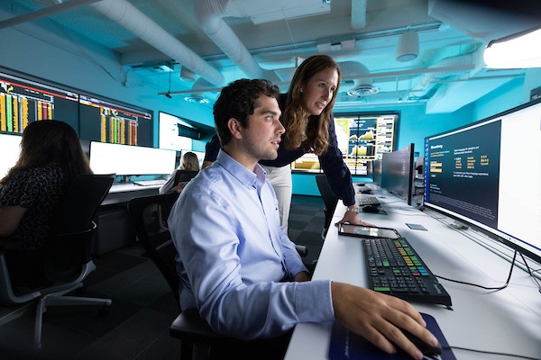 Two individuals looking at a computer