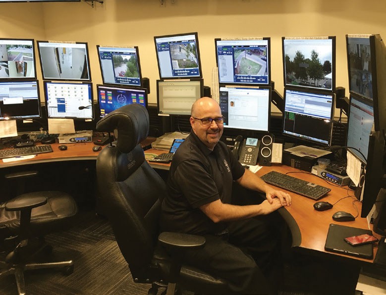 Campus security watch Public safety officer at desk with computer monitors